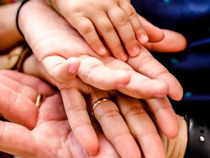 Featured image of hands for Mid-Maine Homeless Shelter & Services' programs.