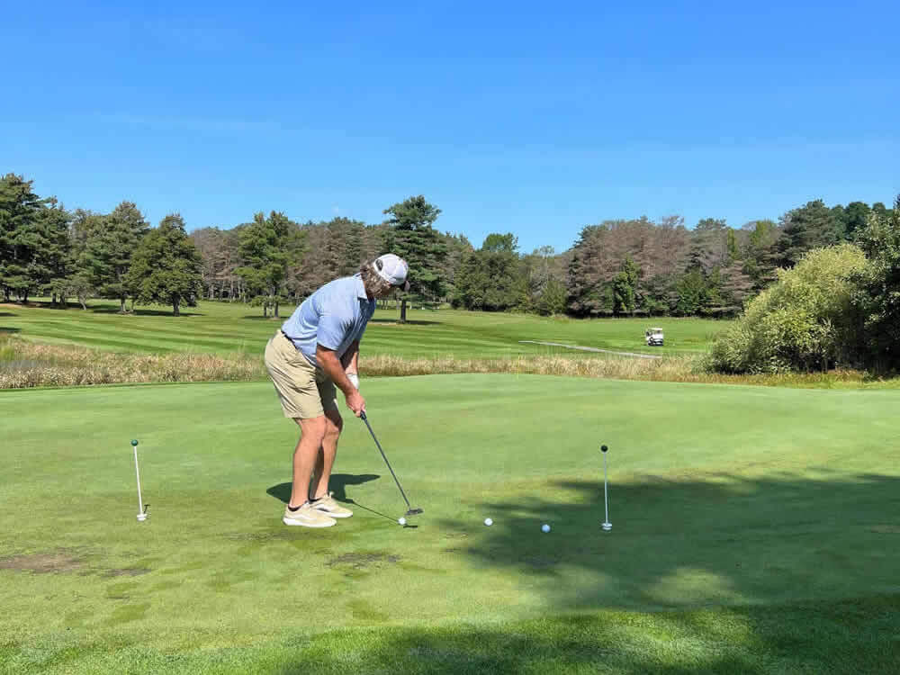 Man playing golf at the Annual Charity Golf Tournament.